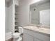 Neat bathroom area with a tub, toilet, sink, shelves, and large mirror at 981 S Sable Blvd # 107, Aurora, CO 80012