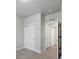 A bedroom with double door closet, leading to a bathroom. and neutral paint at 981 S Sable Blvd # 107, Aurora, CO 80012