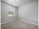 Bright bedroom featuring a window with blinds and neutral carpet, waiting for you! at 981 S Sable Blvd # 107, Aurora, CO 80012