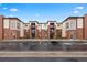 View of exterior of apartments featuring balconies, parking, and sidewalks at 981 S Sable Blvd # 107, Aurora, CO 80012