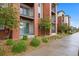 Exterior view of the modern apartments featuring balconies, brick, and professional landscaping at 981 S Sable Blvd # 107, Aurora, CO 80012