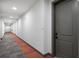 Hallway of building featuring carpet with pops of red leading to the apartment door at 981 S Sable Blvd # 107, Aurora, CO 80012