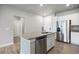 Open concept kitchen features stainless steel appliances, granite countertops and spacious island at 981 S Sable Blvd # 107, Aurora, CO 80012