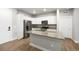 Bright kitchen boasts stainless steel appliances, granite countertops, and a functional center island at 981 S Sable Blvd # 107, Aurora, CO 80012