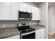 A close up of stainless steel oven and range underneath a stainless steel microwave oven at 981 S Sable Blvd # 107, Aurora, CO 80012