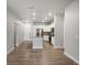 A modern kitchen featuring stainless steel appliances, white cabinets, and a granite countertop island at 981 S Sable Blvd # 107, Aurora, CO 80012
