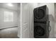 Bright laundry room with stacked washer and dryer and a window for natural light at 981 S Sable Blvd # 107, Aurora, CO 80012