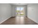 The open living space features hardwood floors and sliding doors opening to an outdoor balcony at 981 S Sable Blvd # 107, Aurora, CO 80012