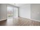 Bright living room featuring wood floors, a large sliding glass door, and neutral paint at 981 S Sable Blvd # 107, Aurora, CO 80012
