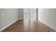 Open room with hardwood floors and access to the balcony at 981 S Sable Blvd # 107, Aurora, CO 80012