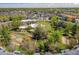 Aerial view of a condo community featuring tennis court, pond, and lush landscaping at 1300 S Parker Rd # 212, Denver, CO 80231