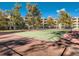 Outdoor tennis court bordered by mature trees and surrounded by condos at 1300 S Parker Rd # 212, Denver, CO 80231