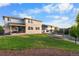 Large backyard with a seating area, trampoline, trees, and landscaping at 4145 Manorbrier Cir, Castle Rock, CO 80104