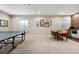 Spacious basement featuring a ping pong table, card table, and carpet flooring at 4145 Manorbrier Cir, Castle Rock, CO 80104