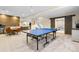 Spacious basement with a ping pong table, kitchenette, and wood accent wall at 4145 Manorbrier Cir, Castle Rock, CO 80104
