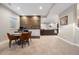 Spacious basement with a kitchenette, wood accent wall, and open floor plan at 4145 Manorbrier Cir, Castle Rock, CO 80104