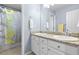 Bright bathroom with dual sinks and granite countertops with shower and tub at 4145 Manorbrier Cir, Castle Rock, CO 80104