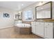 Bright bathroom featuring a soaking tub, double sinks, and granite countertops at 4145 Manorbrier Cir, Castle Rock, CO 80104