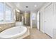 Bright bathroom features dual vanity, separate shower, and a soaking tub at 4145 Manorbrier Cir, Castle Rock, CO 80104