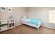 Cozy bedroom featuring a twin bed with bright blue blanket and white bookshelf at 4145 Manorbrier Cir, Castle Rock, CO 80104