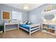 bedroom featuring a desk, white shelves, and blue accent pieces at 4145 Manorbrier Cir, Castle Rock, CO 80104