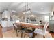 Open dining area with table, chairs, adjacent living room, and staircase at 4145 Manorbrier Cir, Castle Rock, CO 80104