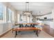Dining room with a large table, wooden bench, and views of the modern kitchen at 4145 Manorbrier Cir, Castle Rock, CO 80104