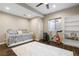 Bright exercise room featuring a daybed, an exercise bike, and a white bookshelf at 4145 Manorbrier Cir, Castle Rock, CO 80104