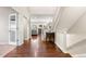 Bright foyer featuring hardwood floors, staircase, and open access to living areas at 4145 Manorbrier Cir, Castle Rock, CO 80104