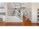 Open foyer with hardwood flooring, staircase, and white railings at 4145 Manorbrier Cir, Castle Rock, CO 80104