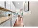 Kitchen with white cabinetry, granite countertops, and hardwood flooring at 4145 Manorbrier Cir, Castle Rock, CO 80104