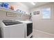 Bright laundry room equipped with modern washer and dryer units at 4145 Manorbrier Cir, Castle Rock, CO 80104