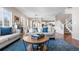 Open-concept living room with hardwood floors, neutral decor, and staircase at 4145 Manorbrier Cir, Castle Rock, CO 80104