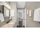 Well-lit bathroom with a granite countertop vanity, mirror, updated fixtures, and tile floor at 6858 Zenobia St # 9, Westminster, CO 80030