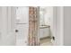 Cozy bathroom featuring a tiled shower, decorative curtain, and a single sink vanity at 6858 Zenobia St # 9, Westminster, CO 80030