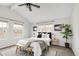 Bright bedroom with neutral tones, featuring a comfortable bed, multiple windows, and stylish decor at 6858 Zenobia St # 9, Westminster, CO 80030