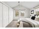 Bright bedroom with multiple windows and a ceiling fan, offering a comfortable and inviting space at 6858 Zenobia St # 9, Westminster, CO 80030