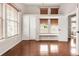 Spacious bedroom featuring wood floors, a cozy window seat, and natural light at 6858 Zenobia St # 9, Westminster, CO 80030