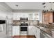Updated kitchen with stainless steel appliances, white cabinets, and granite countertops at 6858 Zenobia St # 9, Westminster, CO 80030