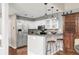 Charming kitchen with white cabinets, stainless steel appliances, and bar seating at 6858 Zenobia St # 9, Westminster, CO 80030