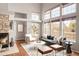 A bright living room area with a stone fireplace, vaulted ceiling, hardwood floors and modern decor at 6858 Zenobia St # 9, Westminster, CO 80030