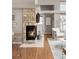 A living room area with a stone fireplace, hardwood floors, vaulted ceiling and modern decor at 6858 Zenobia St # 9, Westminster, CO 80030