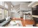A living room area with an open floor plan, vaulted ceiling, modern staircase and hardwood floors at 6858 Zenobia St # 9, Westminster, CO 80030