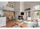 A living room area with vaulted ceiling, fireplace, hardwood floors and modern decor at 6858 Zenobia St # 9, Westminster, CO 80030
