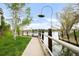 Scenic paved path at lakeside with trees, grass, and a wooden fence at 6858 Zenobia St # 9, Westminster, CO 80030