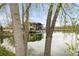Waterfront property with home reflected in the water framed by trees at 6858 Zenobia St # 9, Westminster, CO 80030