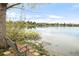 Park bench overlooking a tranquil waterfront with homes in the distance at 6858 Zenobia St # 9, Westminster, CO 80030