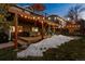 Backyard at night with hot tub and string lights at 8293 S Ogden Cir, Littleton, CO 80122