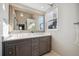 Elegant bathroom with double sinks and a large vanity mirror at 8293 S Ogden Cir, Littleton, CO 80122