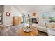 Living room with hardwood floors, fireplace and access to a deck at 8293 S Ogden Cir, Littleton, CO 80122